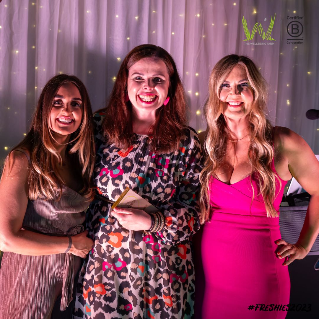 The Planet Protector award winner - Reeds Refillery owner Steph Reed stood with Fresh Perspective directors Laura & Emily Leyland stood infront of a white draped background with fairy lights.